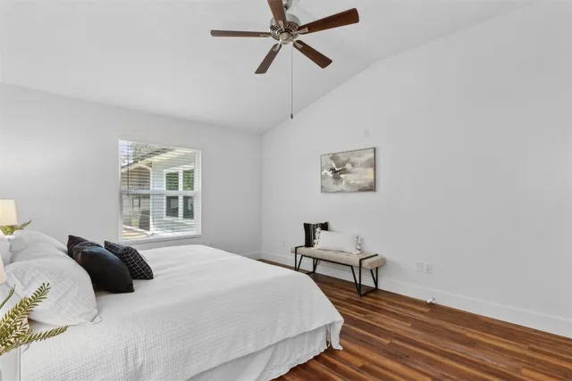 a bathroom with a bathtub shower sink vanity mirror and toilet