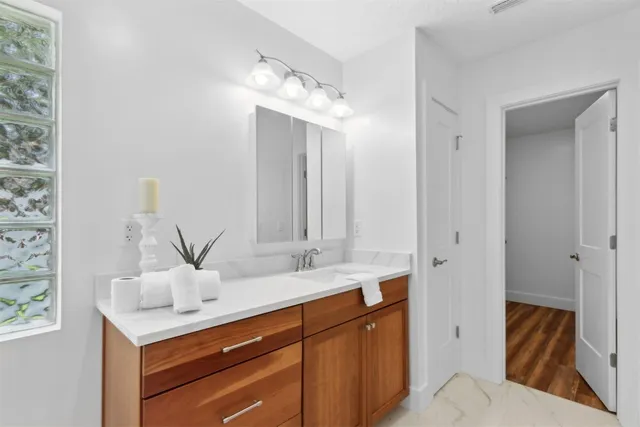 a view of an empty room with closet and wooden floor