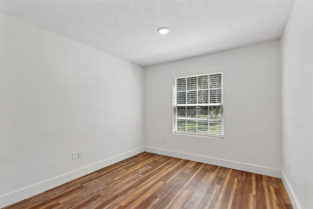 a living room with furniture and floor to ceiling windows