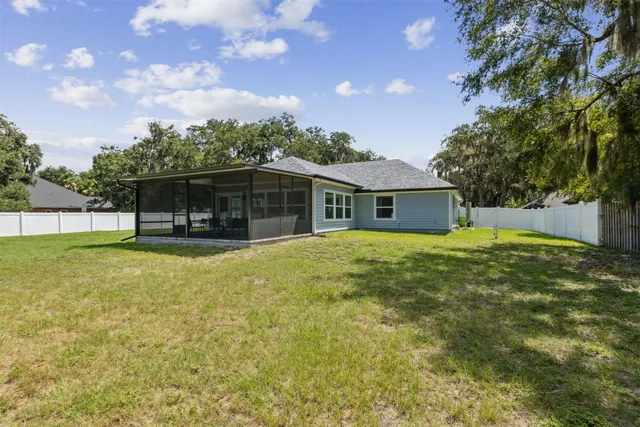 an aerial view of residential house with outdoor space and lake view