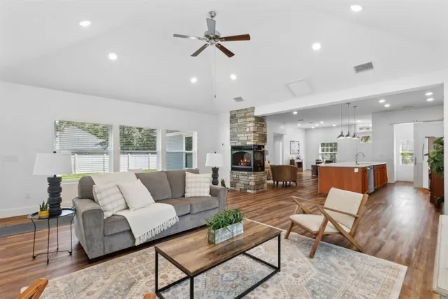 a view of a house with a big yard and large trees