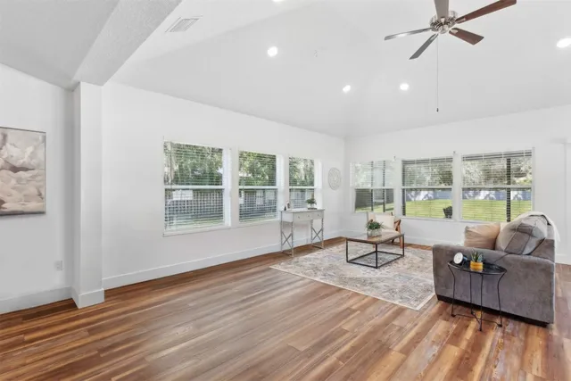 a front view of a house with a garden and yard