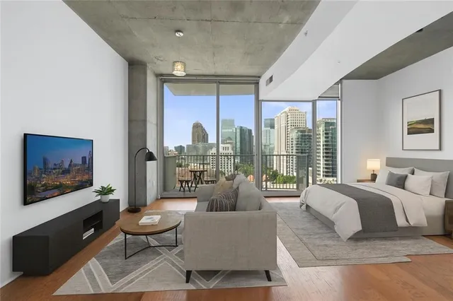 a living room with furniture large window and flat screen tv