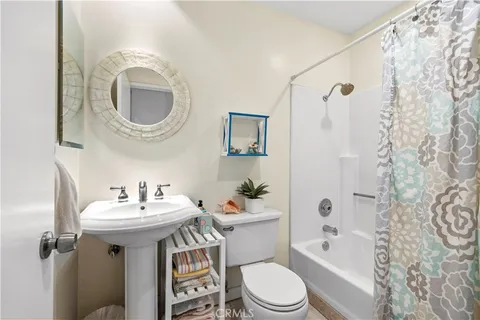 a bathroom with a sink toilet a mirror and shower