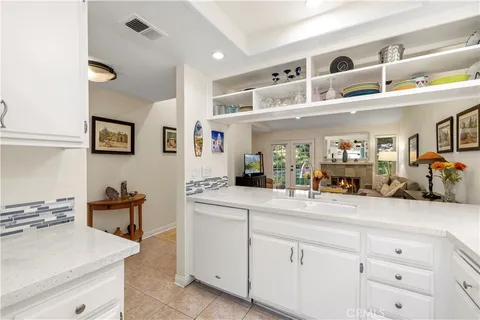 a kitchen with cabinets and window