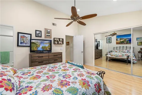 a bedroom with a bed and a flat screen tv