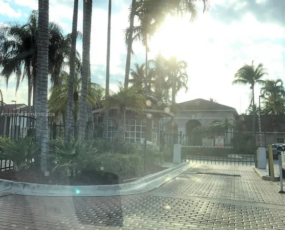 a kitchen with granite countertop a sink a stove and white cabinets