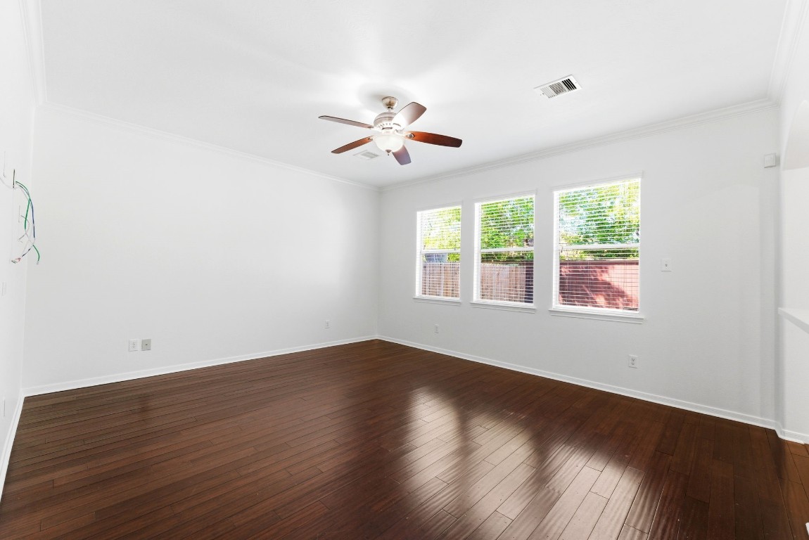 6407 Wilshire Ridge Houston, TX 77040 - Photo 11 of 37 an empty room with wooden floor ceiling fan and windows