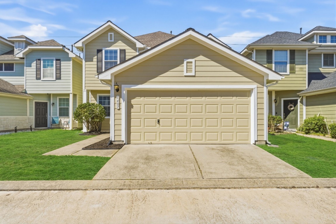 6407 Wilshire Ridge Houston, TX 77040 - Photo 2 of 37 a front view of a house with a yard and garage