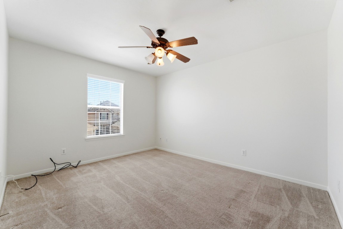 6407 Wilshire Ridge Houston, TX 77040 - Photo 28 of 37 an empty room with windows and fan