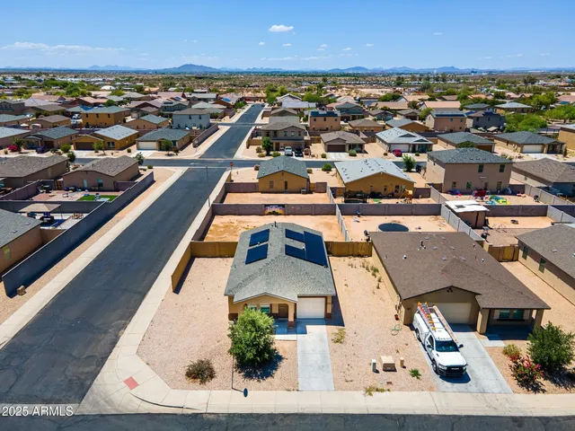an aerial view of residential houses with city view