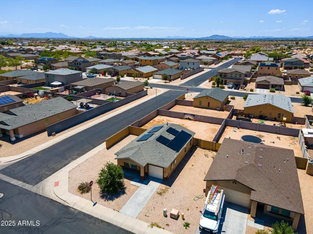 an aerial view of residential houses with outdoor space