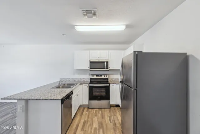 a kitchen with a refrigerator stove and oven