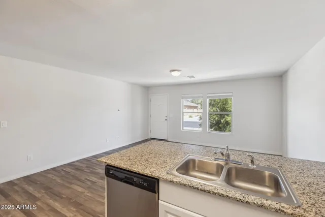 a kitchen with granite countertop a sink and a window
