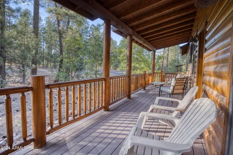 a view of balcony with wooden floor and outdoor seating