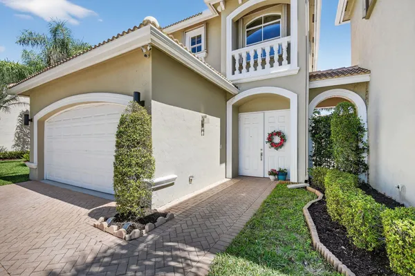a view of a house with swimming pool and sitting area