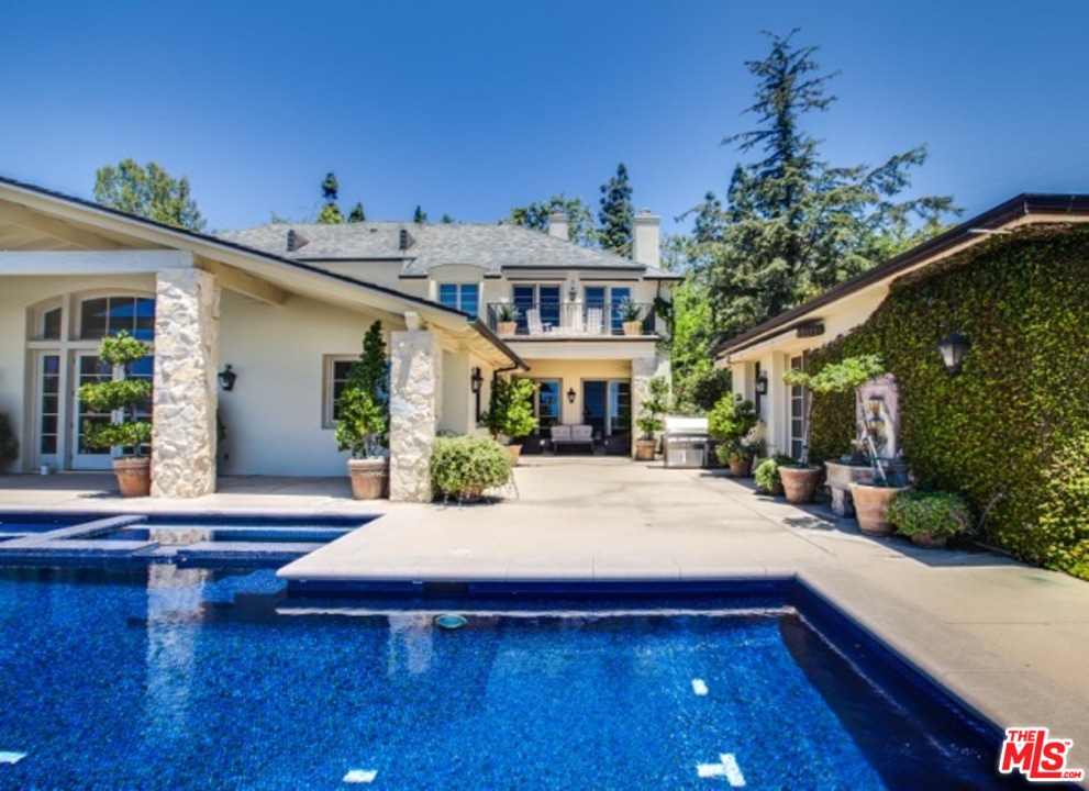 12801 Chalon Road Los Angeles, CA 90049 - Photo 12 of 16 a view of a house with pool and sitting area