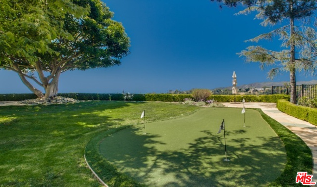12801 Chalon Road Los Angeles, CA 90049 - Photo 14 of 16 a view of an outdoor space and swimming pool