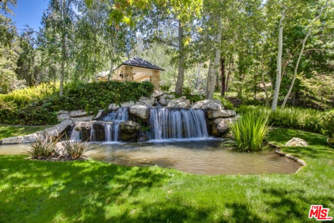 12801 Chalon Road Los Angeles, CA 90049 - Photo 2 of 16 a view of backyard with green space