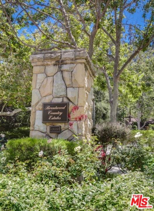 12801 Chalon Road Los Angeles, CA 90049 - Photo 3 of 16 a backyard of a house with lots of green space