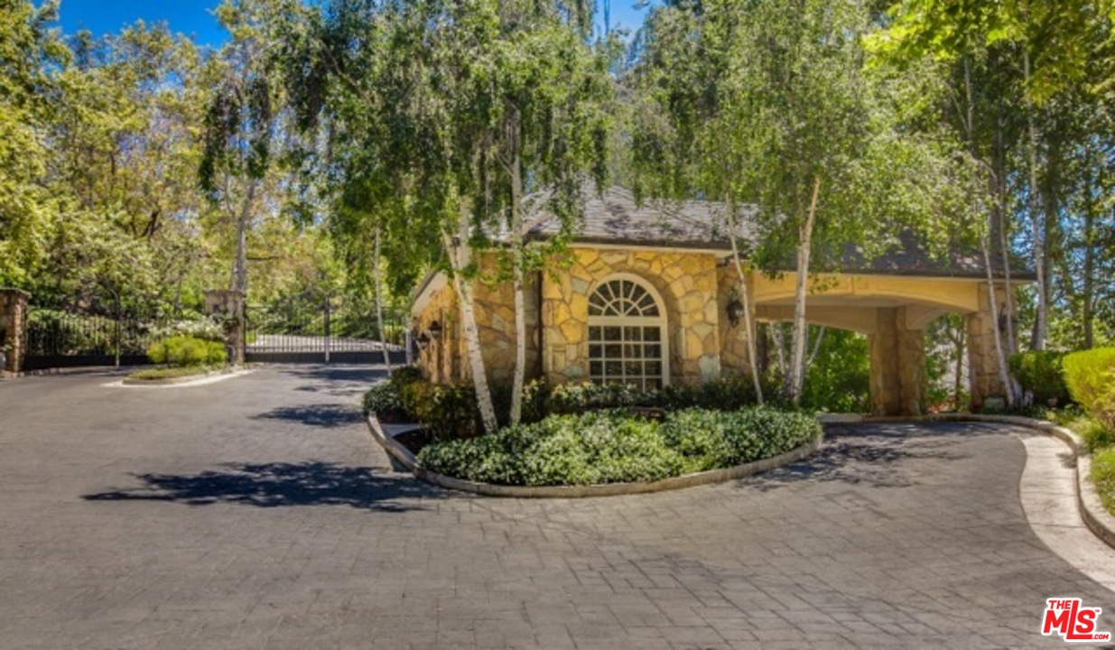 12801 Chalon Road Los Angeles, CA 90049 - Photo 4 of 16 a view of a street with a trees