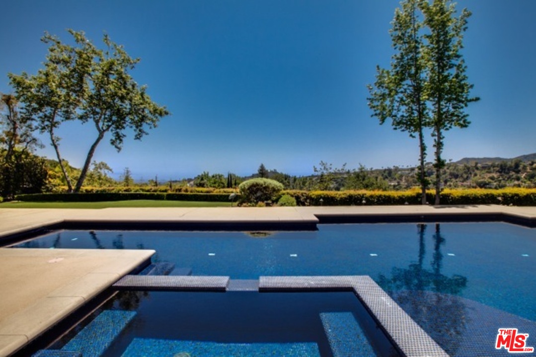 12801 Chalon Road Los Angeles, CA 90049 - Photo 9 of 16 a view of a lake with a outdoor space