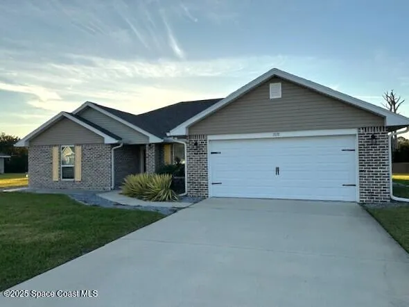 a front view of house with yard and green space