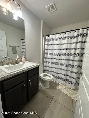 a bathroom with a double vanity sink toilet and a shower