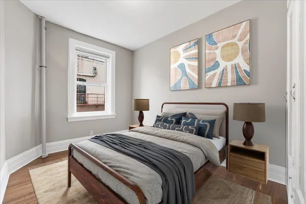 a bedroom with a bed and a window