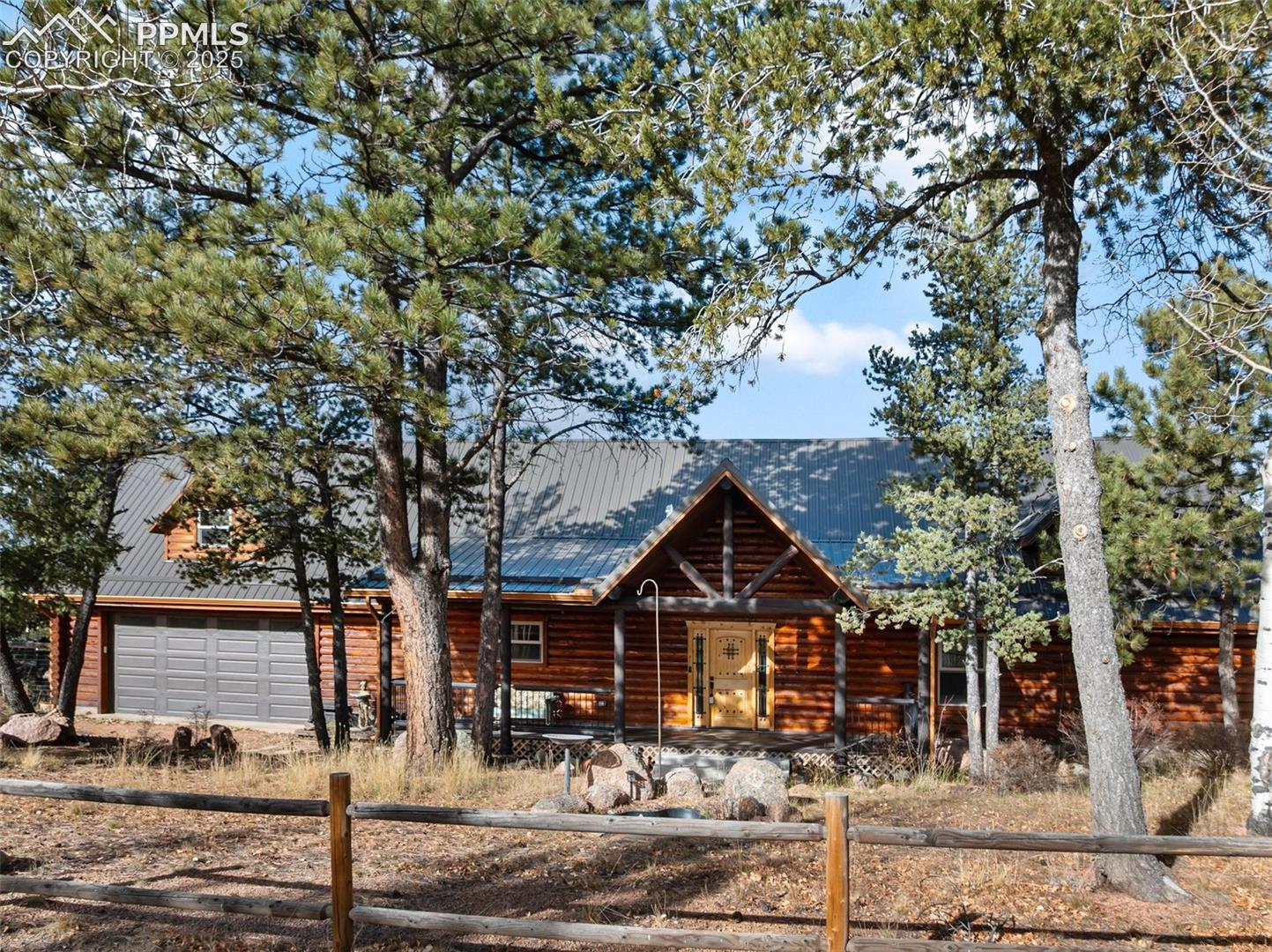 111 Blue Spruce Road Divide, CO 80814 - Photo 1 of 46 Beautiful custom build log home with fenced front, metal roof, separate workshop and majestic views.