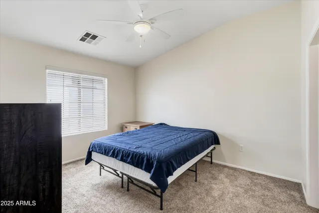 a bedroom with a bed and window
