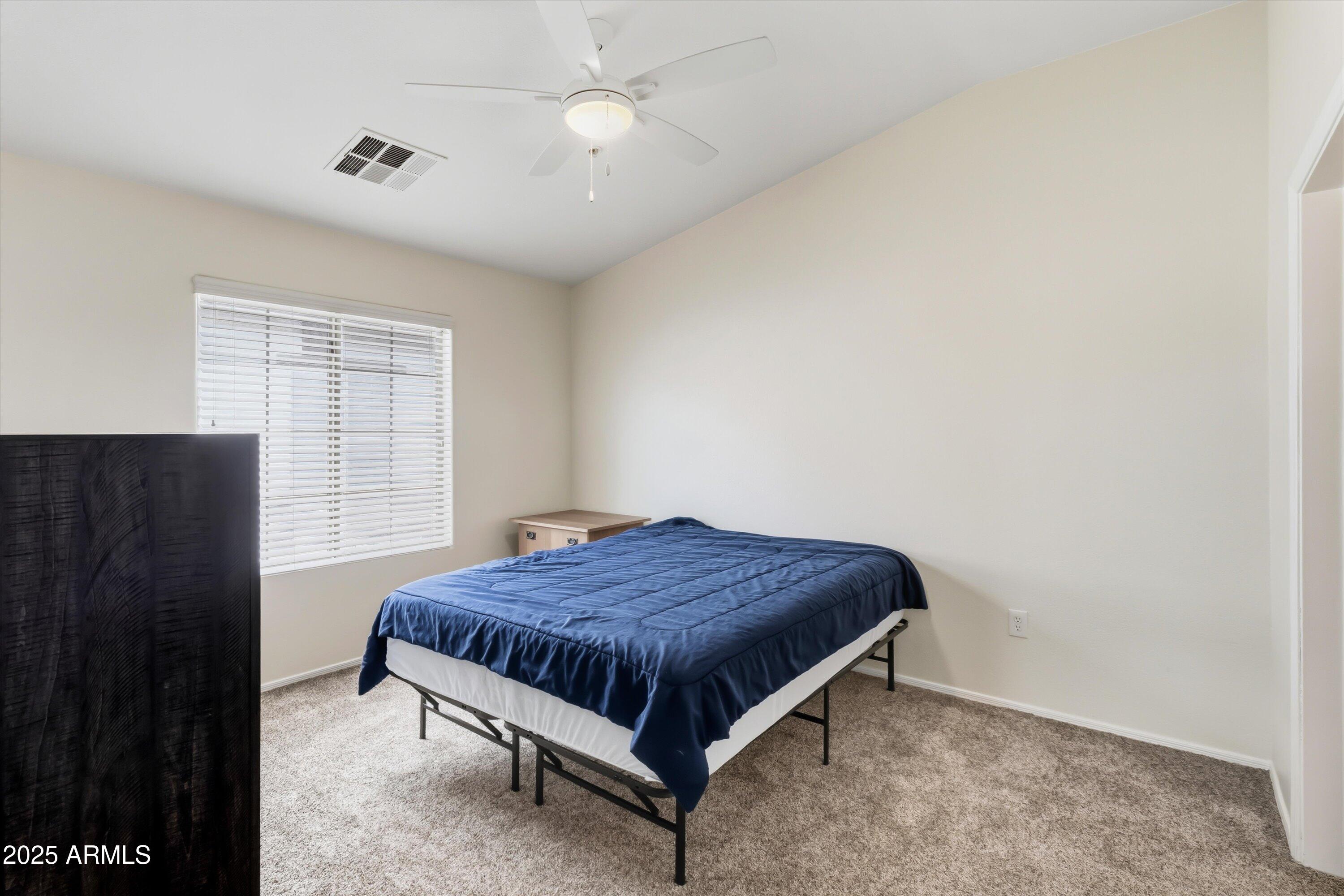 2727 North Price Road, Unit 50 Chandler, AZ 85224 - Photo 12 of 32 a bedroom with a bed and window