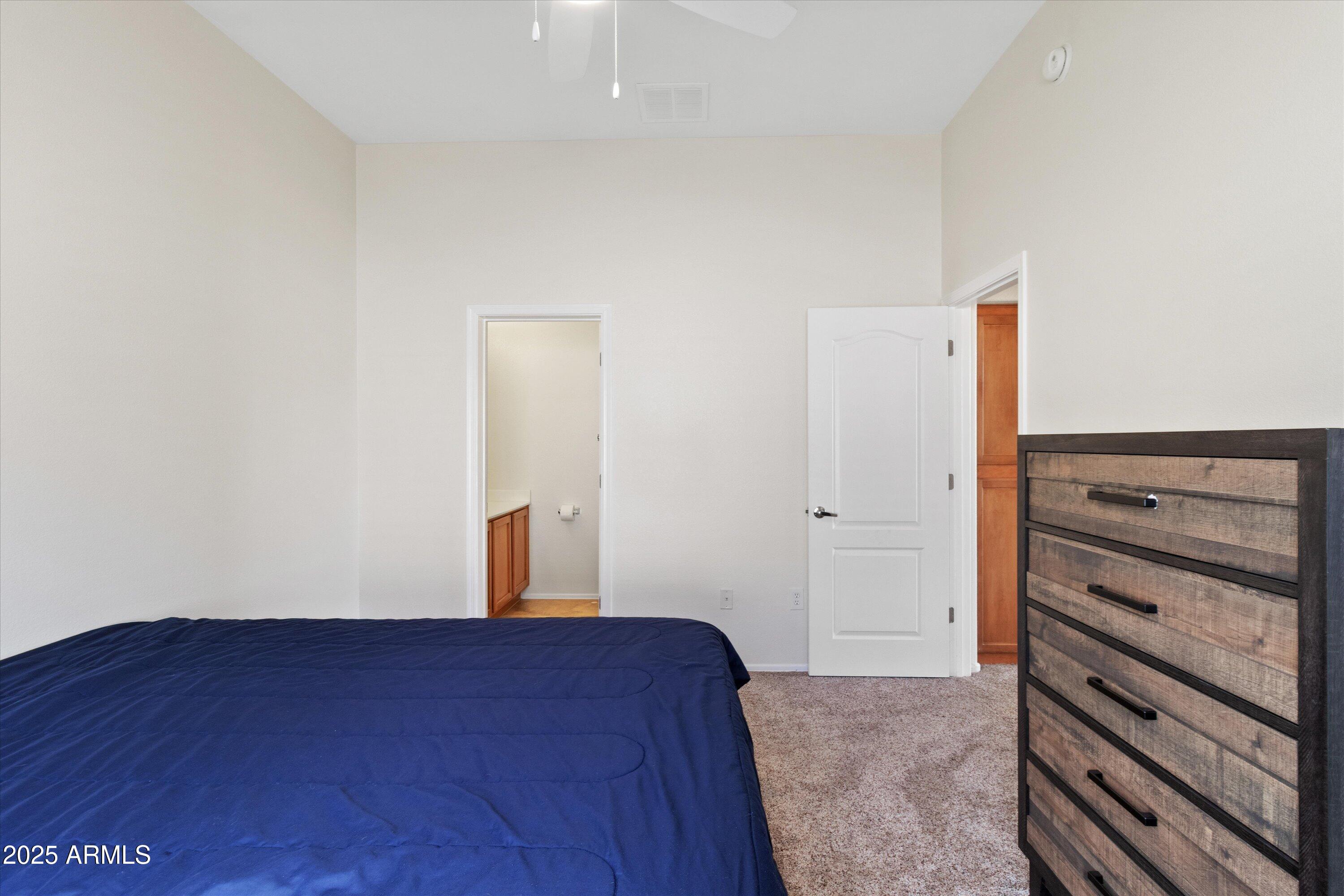 2727 North Price Road, Unit 50 Chandler, AZ 85224 - Photo 13 of 32 a bedroom with a bed and a dresser