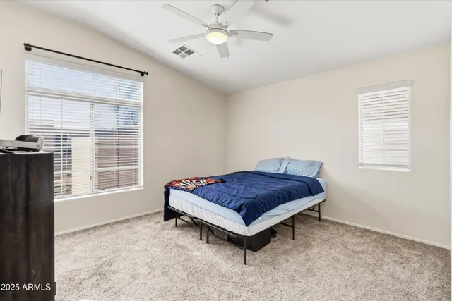 a living room with a bed furniture and a window