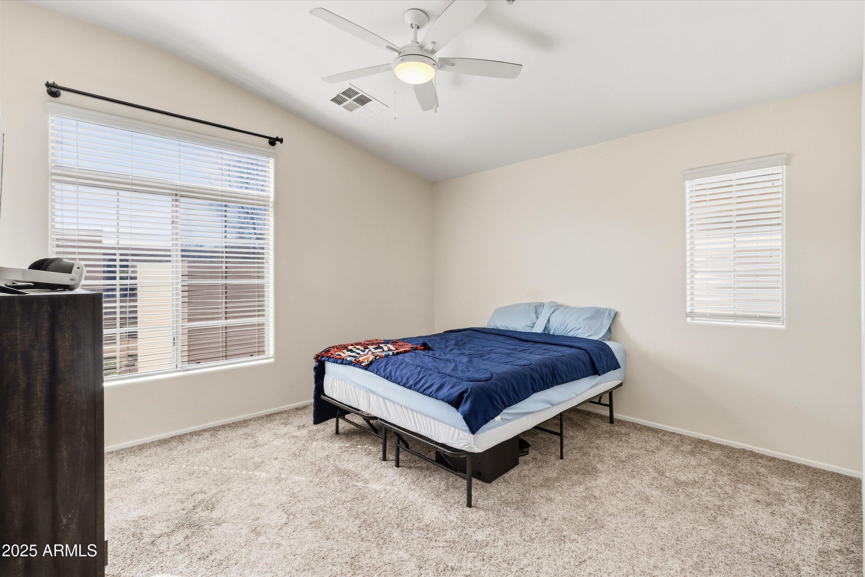 2727 North Price Road, Unit 50 Chandler, AZ 85224 - Photo 16 of 32 a living room with a bed furniture and a window