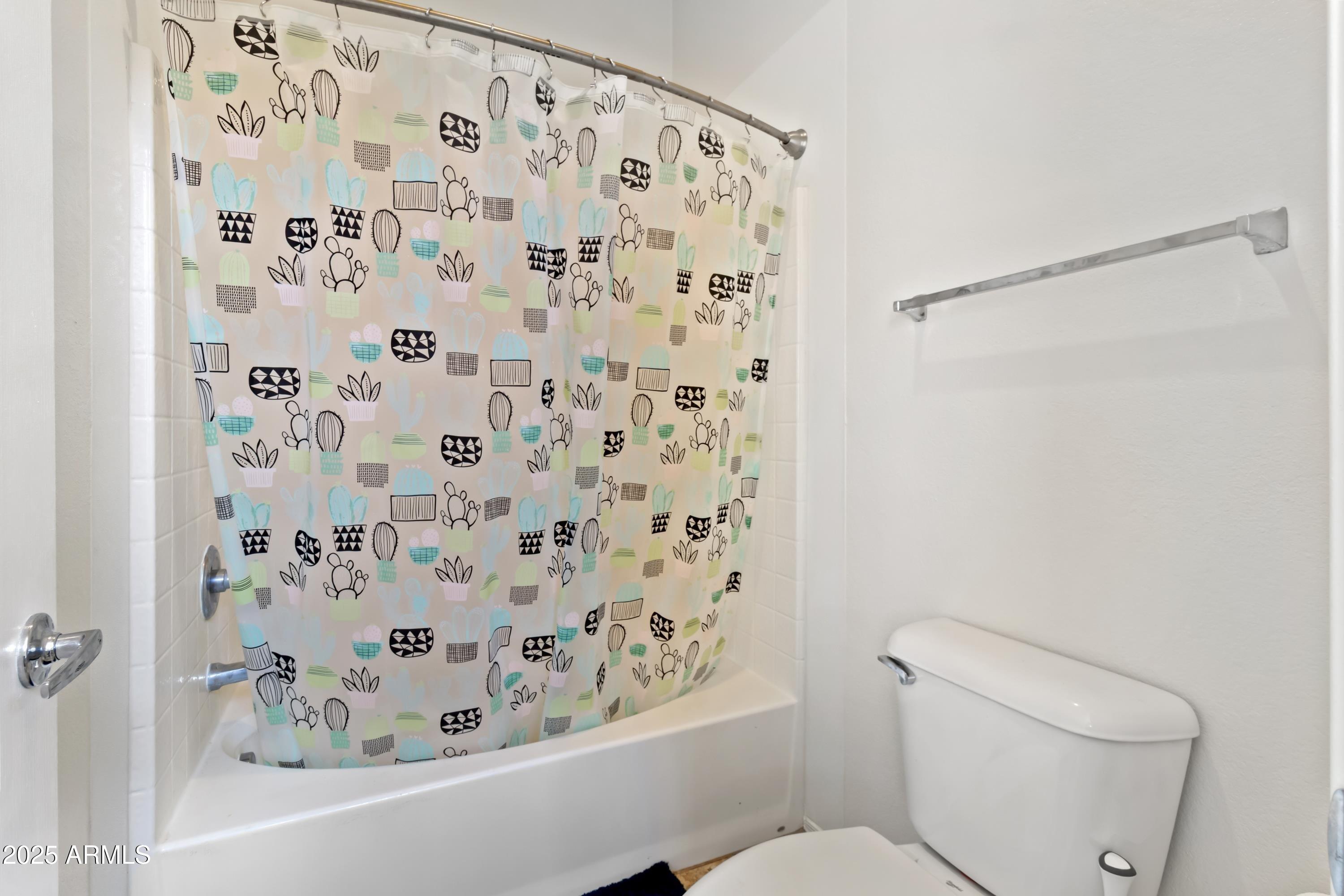 2727 North Price Road, Unit 50 Chandler, AZ 85224 - Photo 19 of 32 a white toilet sitting next to a shower curtain