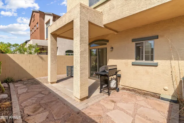 a view of a house with backyard and sitting area