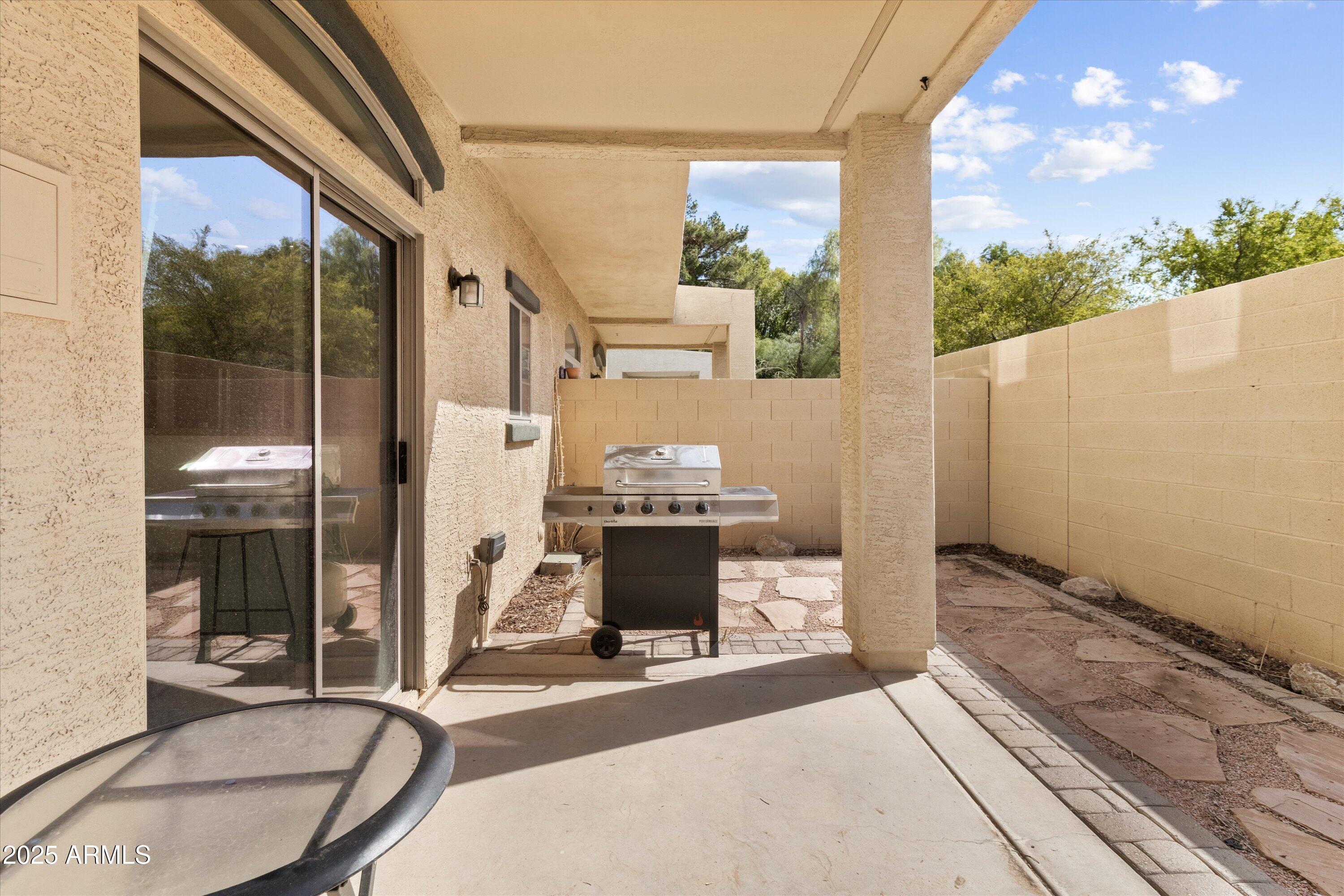 2727 North Price Road, Unit 50 Chandler, AZ 85224 - Photo 26 of 32 a view of a balcony with a fireplace and potted plants