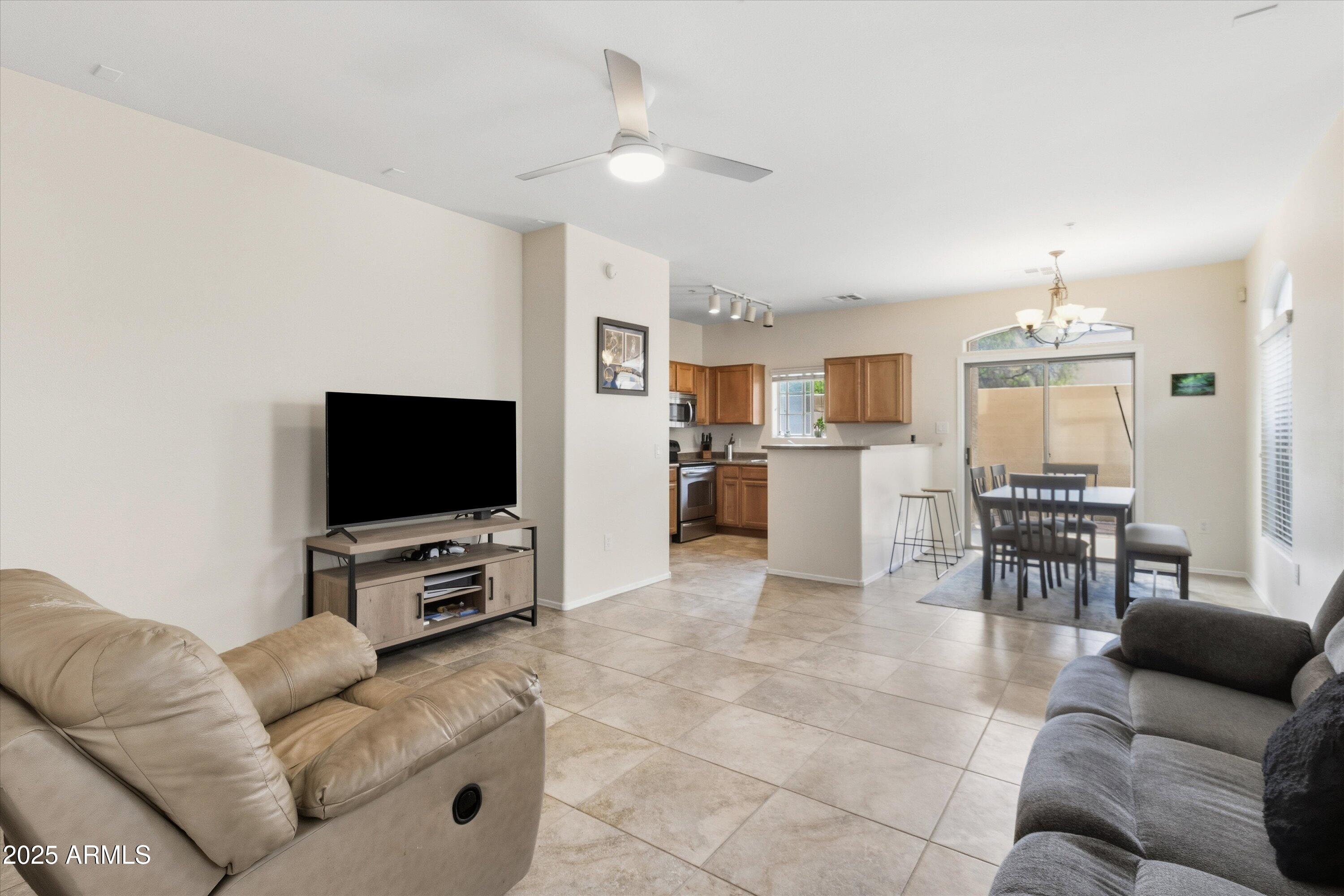 2727 North Price Road, Unit 50 Chandler, AZ 85224 - Photo 3 of 32 a living room with furniture and a flat screen tv