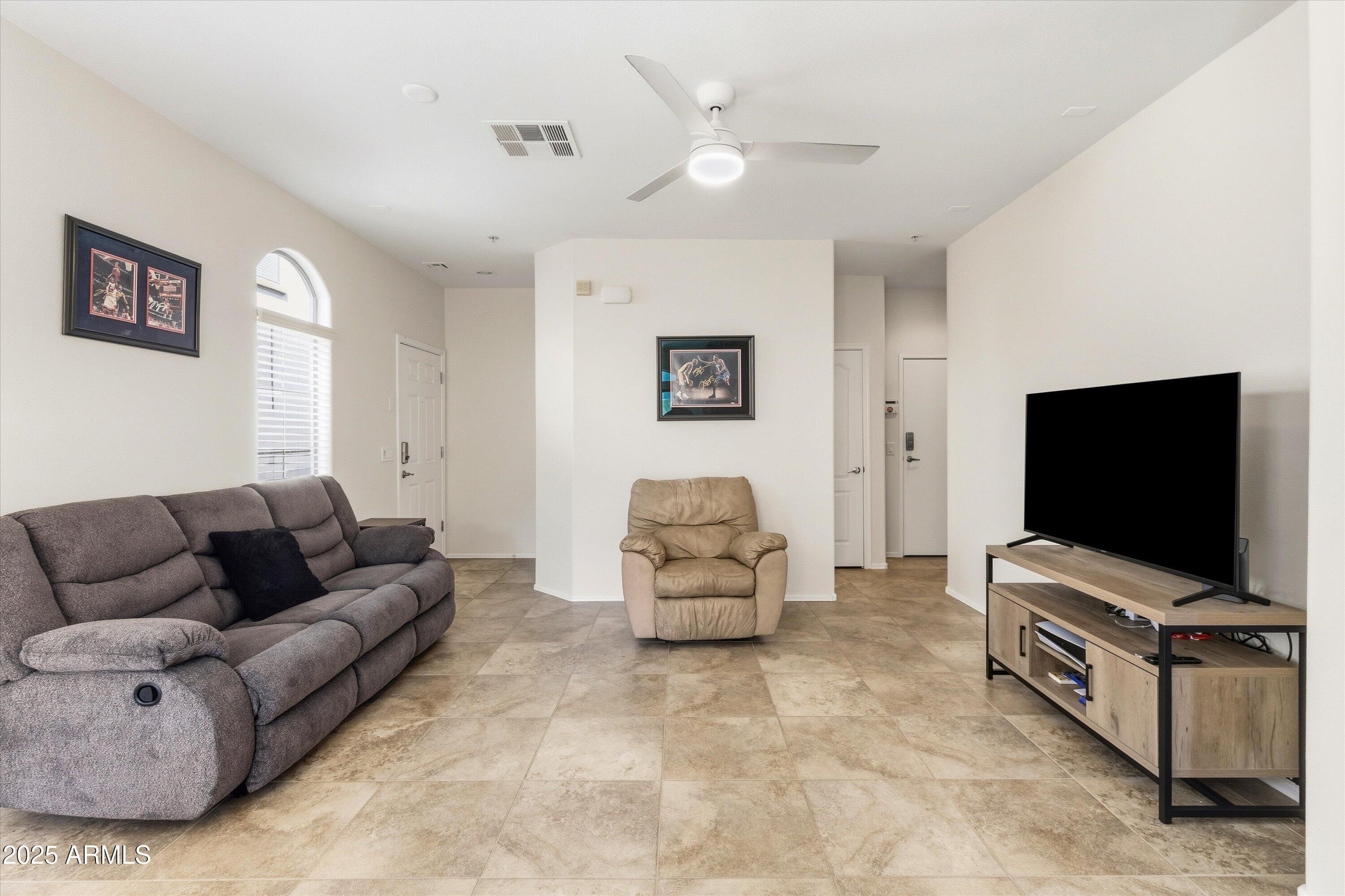 2727 North Price Road, Unit 50 Chandler, AZ 85224 - Photo 5 of 32 a living room with furniture and a flat screen tv