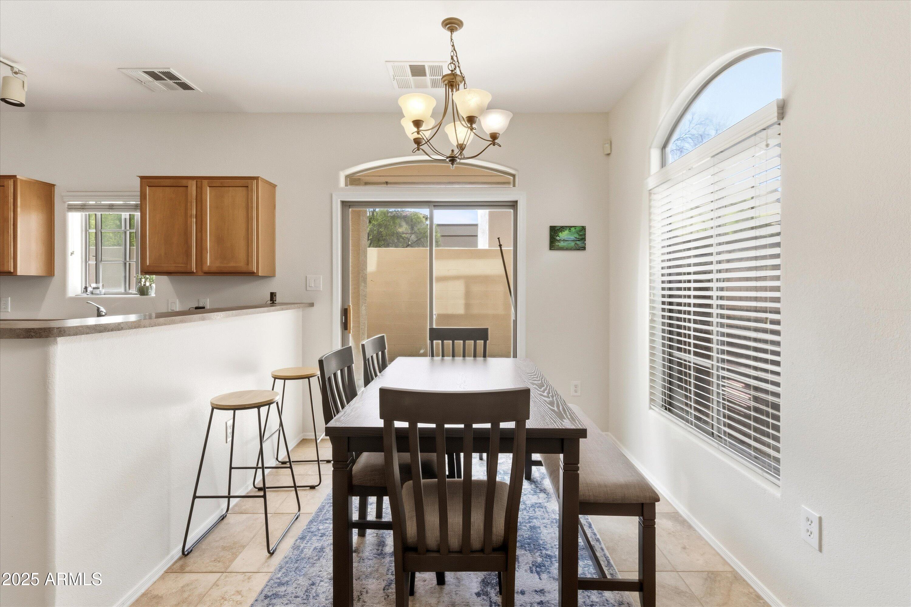 2727 North Price Road, Unit 50 Chandler, AZ 85224 - Photo 6 of 32 a dining room with furniture and window