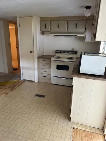 a kitchen with a stove and a cabinet