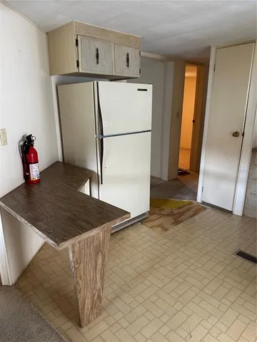 a kitchen with stainless steel appliances a refrigerator and a stove