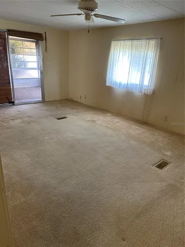 an empty room with windows and closet
