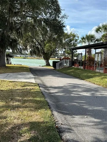 a view of yard with swimming pool and green space