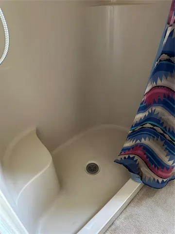 a bathroom with a shower and a toilet