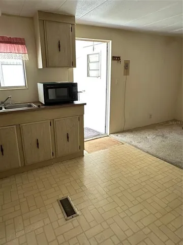 a kitchen with stainless steel appliances a stove a sink and a refrigerator
