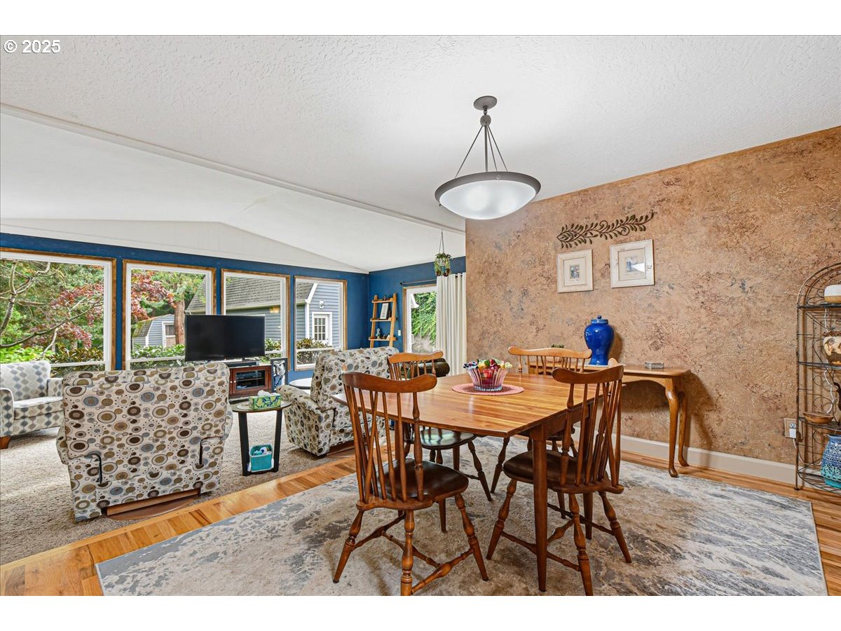 1820 Southwest Heiney Road Gresham, OR 97080 - Photo 11 of 48 a view of a dining room and livingroom with furniture wooden floor a chandelier