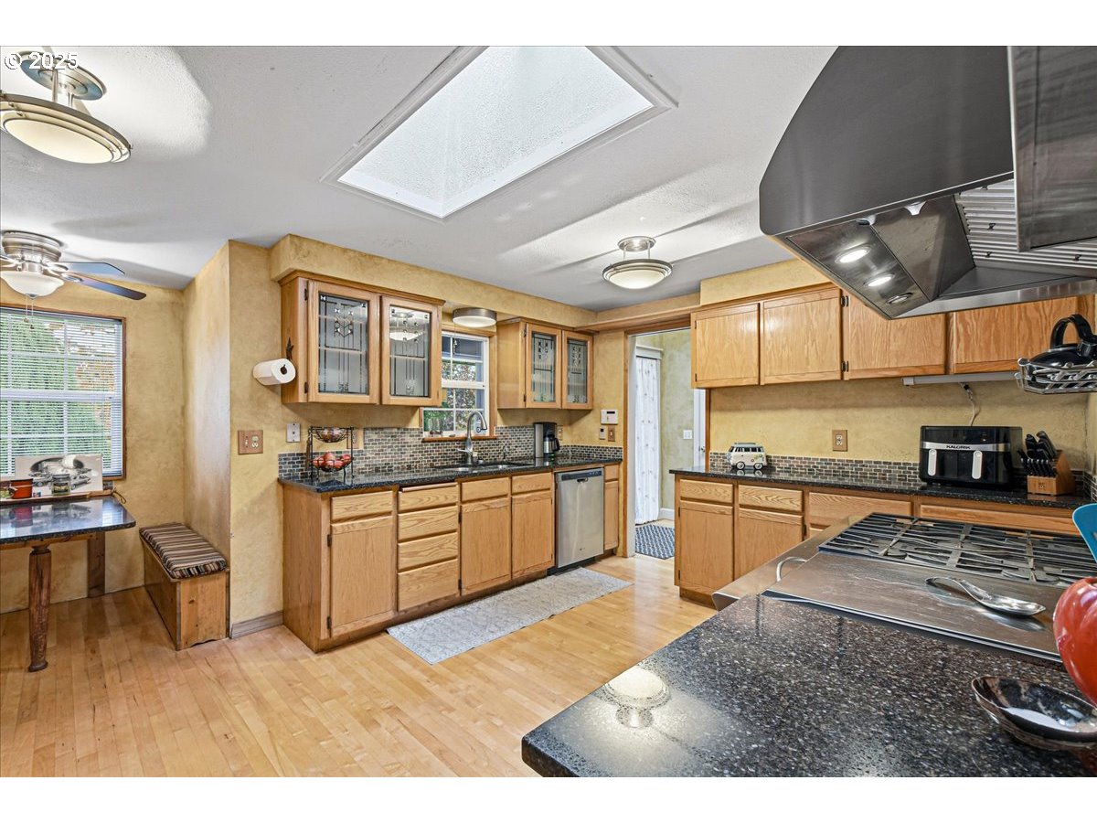 1820 Southwest Heiney Road Gresham, OR 97080 - Photo 13 of 48 a kitchen with stainless steel appliances kitchen island granite countertop a sink and cabinets