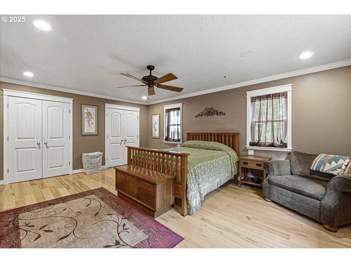 1820 Southwest Heiney Road Gresham, OR 97080 - Photo 21 of 48 a spacious bedroom with a bed a couch and dresser